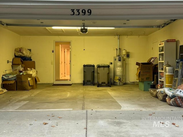 garage with water heater and a garage door opener