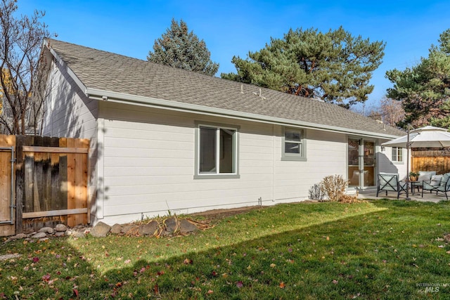 rear view of house featuring a yard and a patio area