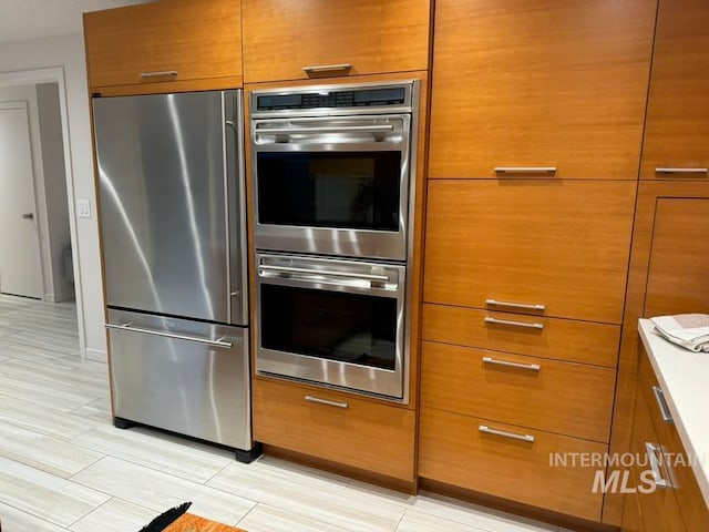 kitchen with light wood-type flooring and stainless steel appliances