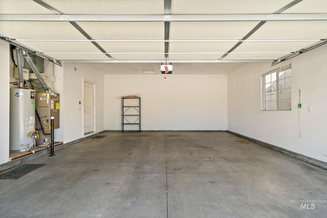 garage with gas water heater and a garage door opener