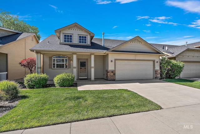 view of front of house with a garage, a front lawn, concrete driveway, a shingled roof, and stone siding