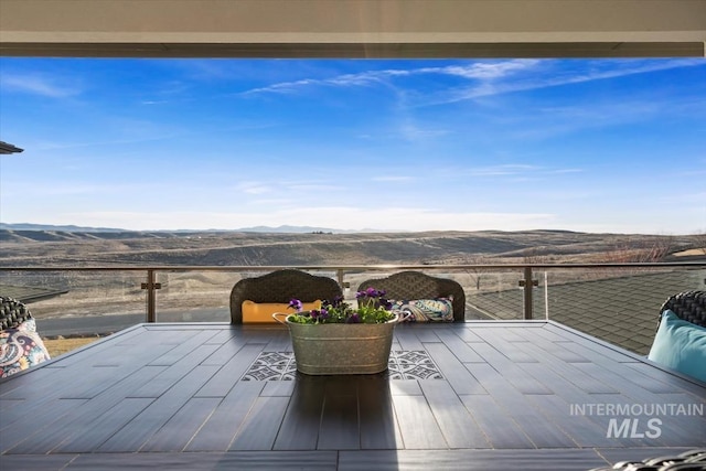 view of patio / terrace with a mountain view and a balcony