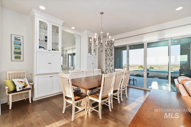 dining area featuring recessed lighting, an inviting chandelier, and dark wood-style floors