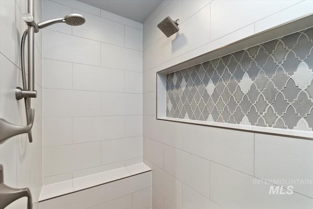 full bath featuring tiled shower