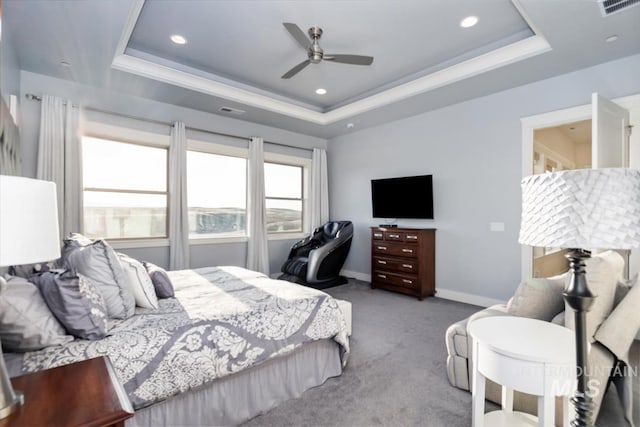 bedroom featuring carpet flooring, a raised ceiling, and baseboards