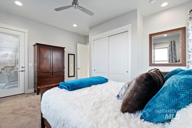 bedroom featuring recessed lighting, a closet, light colored carpet, and ceiling fan