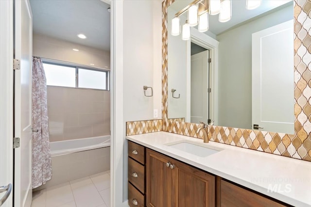 full bathroom featuring decorative backsplash, shower / tub combo with curtain, vanity, and tile patterned flooring