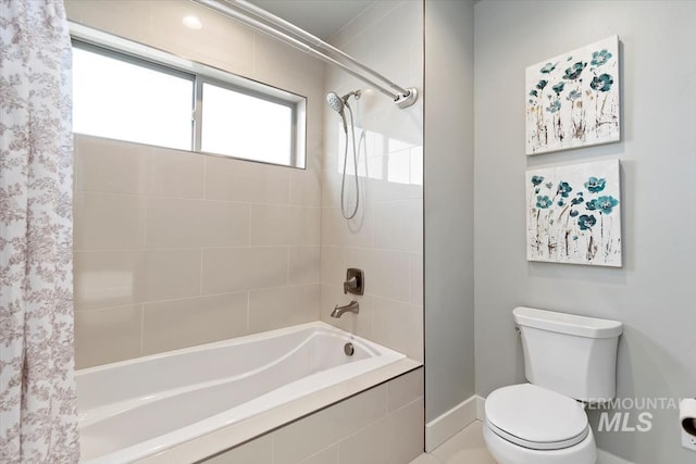 bathroom featuring toilet and shower / tub combo