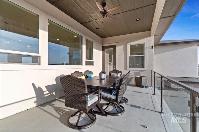 view of patio featuring outdoor dining space and a ceiling fan