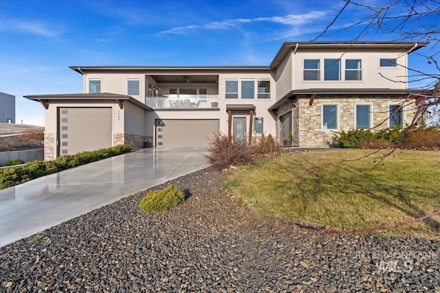 prairie-style home featuring a balcony, stucco siding, concrete driveway, a garage, and stone siding