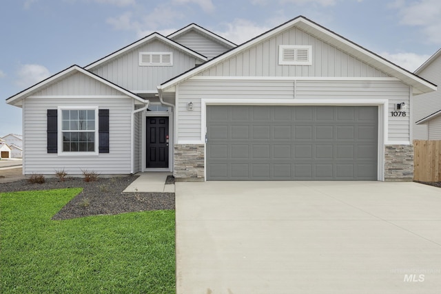 1078 Quartzite Ave, Middleton, ID 83644 - view of front facade with a garage, fence, concrete driveway, and stone siding