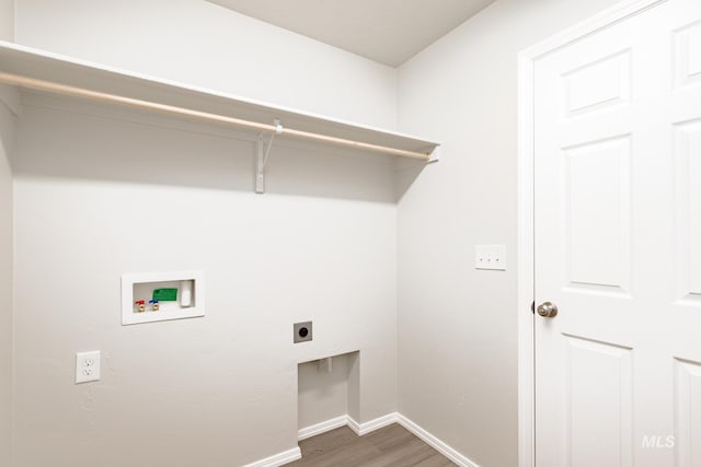 washroom with laundry area, hookup for a washing machine, baseboards, electric dryer hookup, and wood finished floors