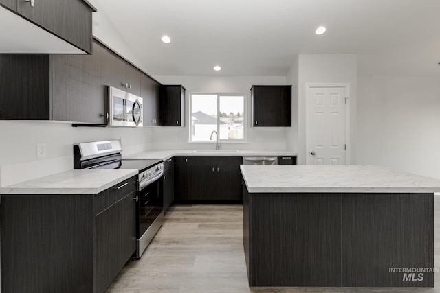 1078 Quartzite Ave, Middleton, ID 83644 - kitchen with a kitchen island, white cabinetry, light wood finished floors, appliances with stainless steel finishes, and vaulted ceiling