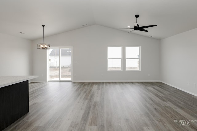 1078 Quartzite Ave, Middleton, ID 83644 - empty room featuring a notable chandelier, light wood-style floors, baseboards, lofted ceiling, and visible vents