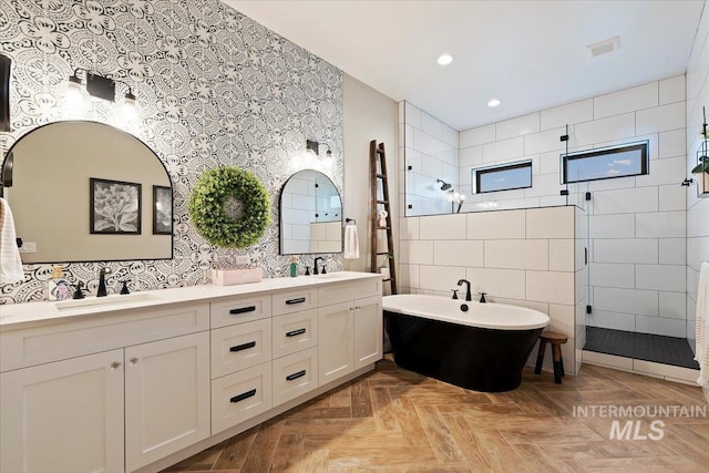 bathroom featuring vanity, separate shower and tub, parquet floors, and tile walls