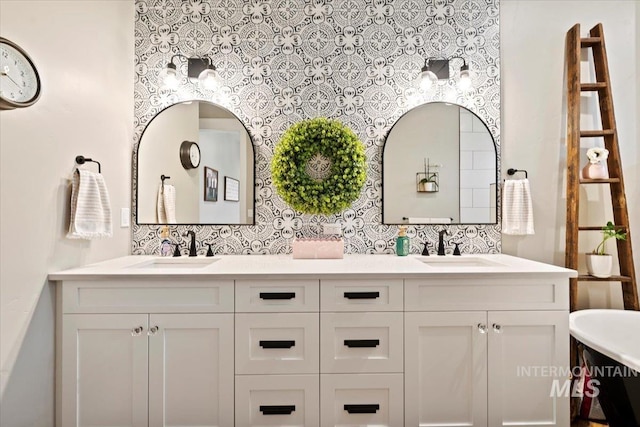 bathroom featuring decorative backsplash, vanity, and a bathing tub