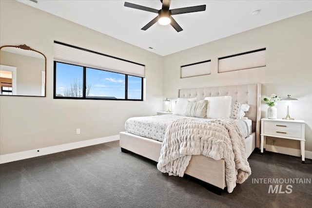 bedroom with ceiling fan and dark carpet