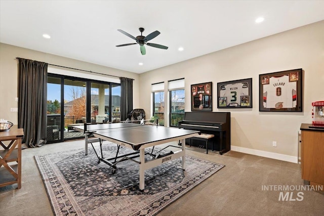 game room featuring plenty of natural light, ceiling fan, and light colored carpet