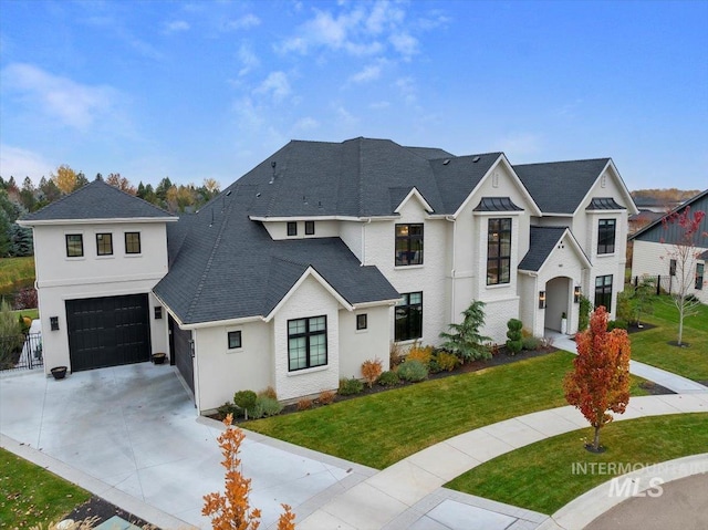 view of front of property with a garage and a front yard