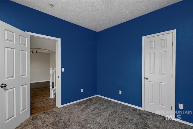 unfurnished bedroom with carpet and a textured ceiling