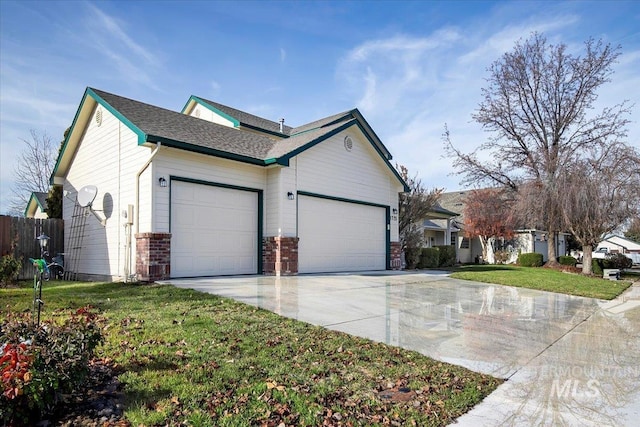 view of side of property with a yard and a garage