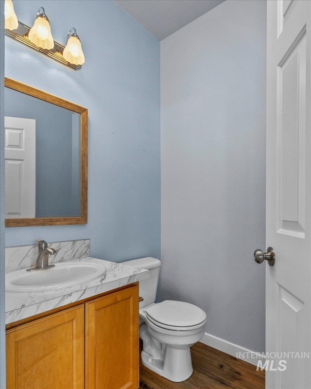 bathroom featuring hardwood / wood-style flooring, vanity, and toilet