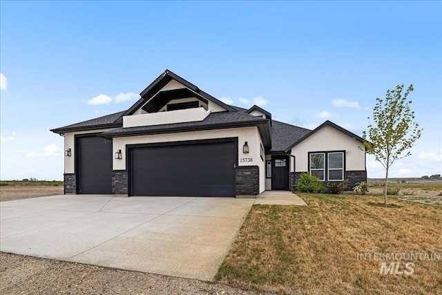 view of front of property with a garage and a front yard