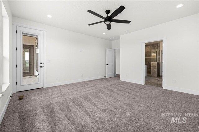 unfurnished room featuring ceiling fan and carpet