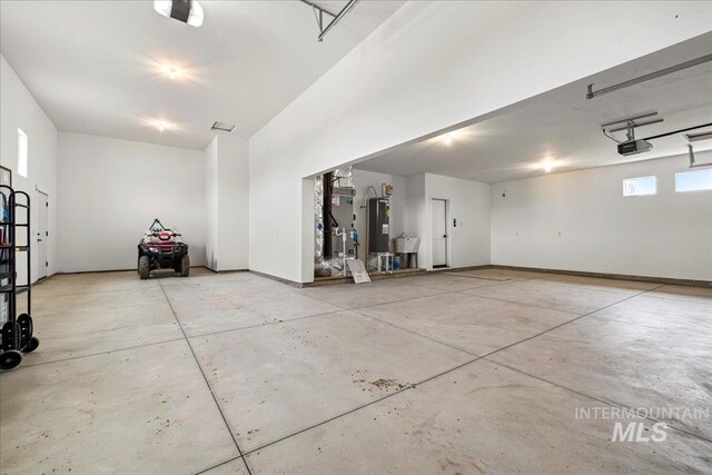 garage with water heater, sink, and a garage door opener