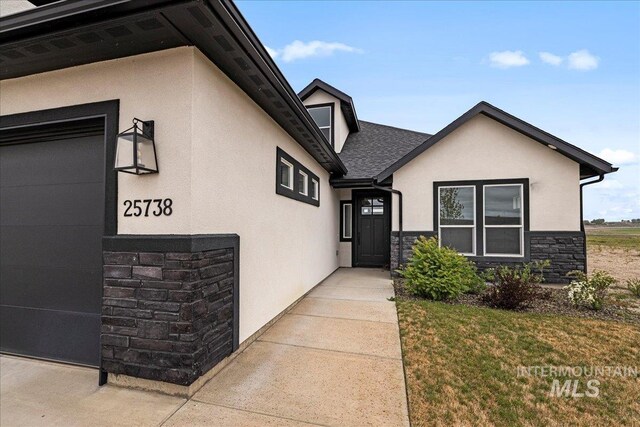 doorway to property with a lawn