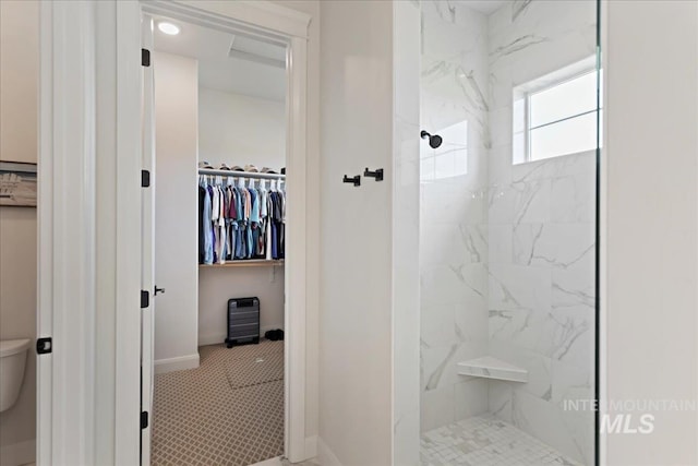 20150 Silver Spur Dr, Wilder, ID 83676 - bathroom featuring a walk in closet, a marble finish shower, toilet, and baseboards