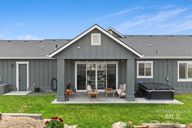 20150 Silver Spur Dr, Wilder, ID 83676 - back of house with board and batten siding, a patio, and a shingled roof