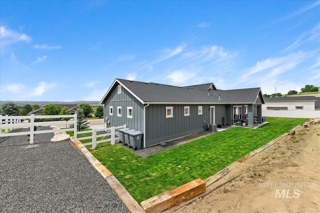 20150 Silver Spur Dr, Wilder, ID 83676 - view of property exterior with board and batten siding, a patio, a shingled roof, and central air condition unit
