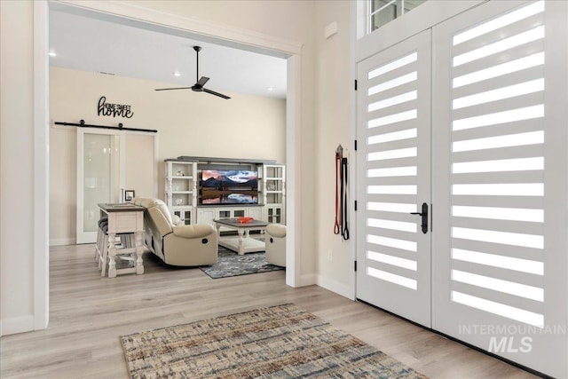 20150 Silver Spur Dr, Wilder, ID 83676 - foyer featuring a barn door, a ceiling fan, wood finished floors, and baseboards