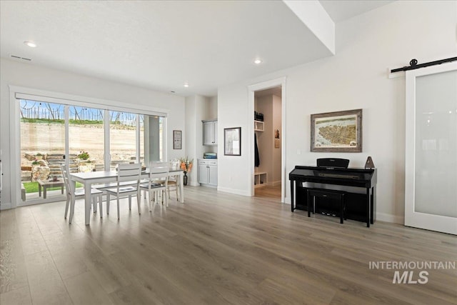 20150 Silver Spur Dr, Wilder, ID 83676 - dining room featuring a barn door, wood finished floors, baseboards, and recessed lighting