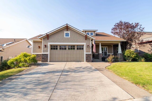 craftsman-style home featuring a garage and a front yard