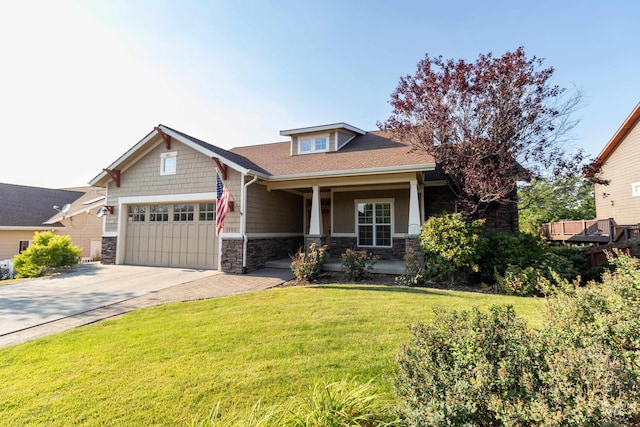 craftsman-style home featuring a front yard and a garage