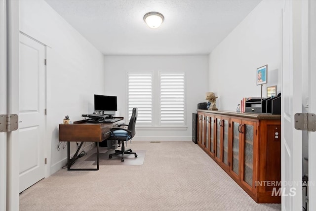 office space with carpet and baseboards