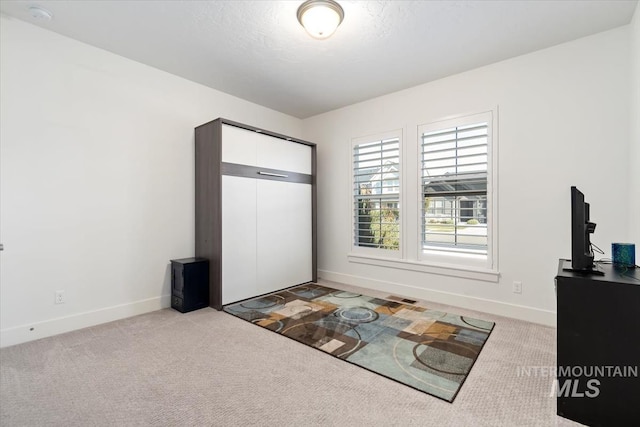 unfurnished bedroom with carpet floors and baseboards