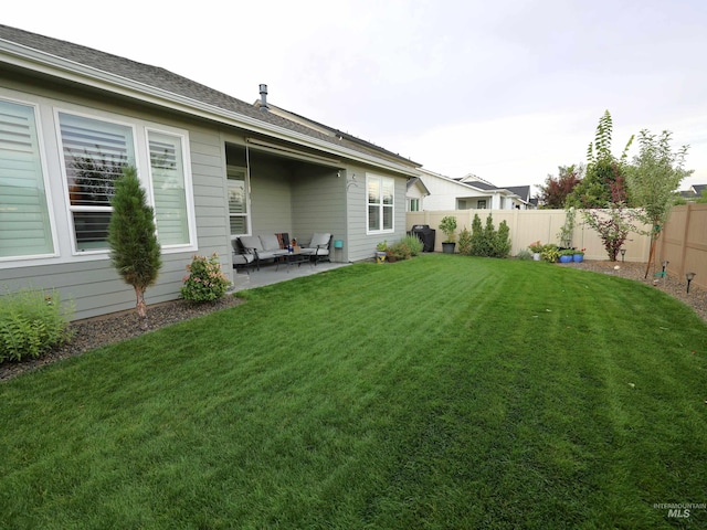 view of yard featuring a patio area and a fenced backyard