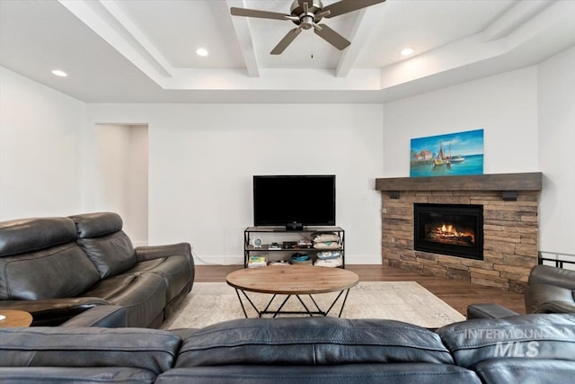 living area with recessed lighting, a fireplace, wood finished floors, and beamed ceiling