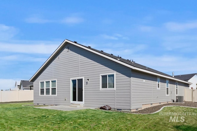 back of property featuring cooling unit, a yard, and a patio area