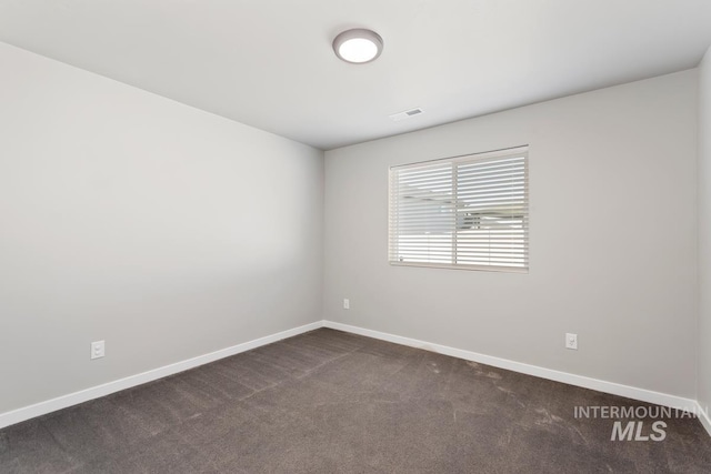 empty room featuring dark colored carpet