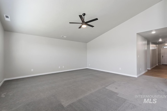 empty room featuring ceiling fan, lofted ceiling, and carpet flooring