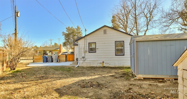 back of house with a patio area and a shingled roof