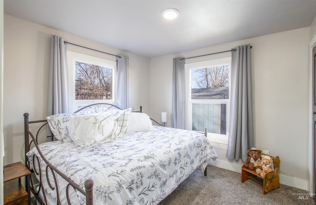 carpeted bedroom featuring baseboards