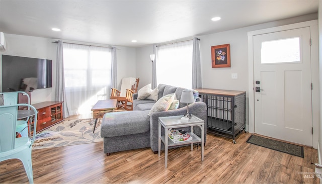 living room with recessed lighting and wood finished floors