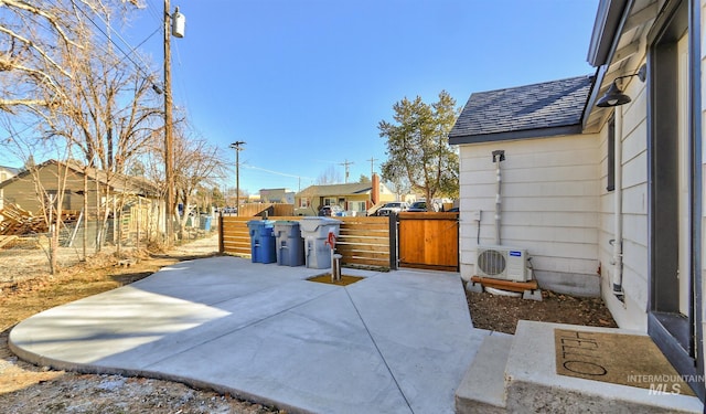 view of patio / terrace with ac unit, a gate, and fence