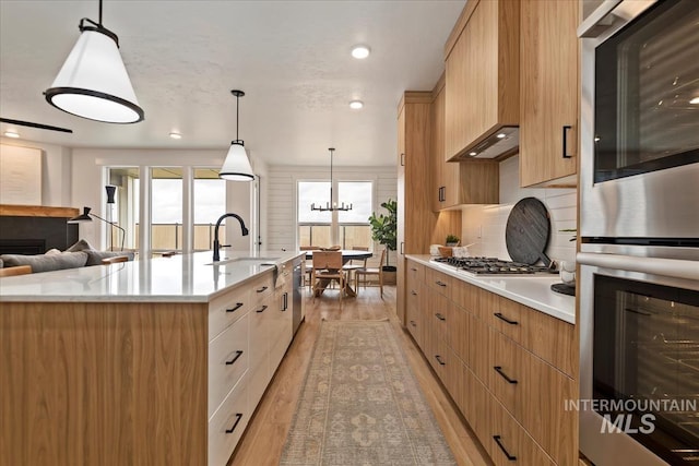 4628 N Camp Creek Ave, Meridian, ID 83646 - kitchen featuring a sink, appliances with stainless steel finishes, a healthy amount of sunlight, and light wood-type flooring