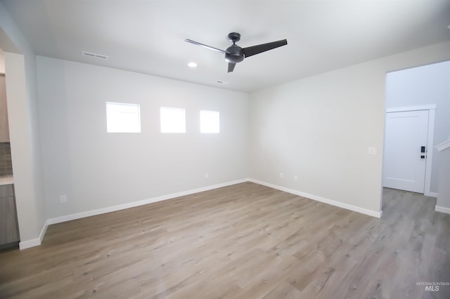 empty room with light wood-style floors, baseboards, a ceiling fan, and recessed lighting